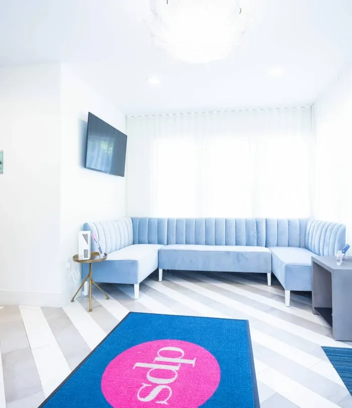 The waiting area with a pale blue banquette and the sdp logo rug.